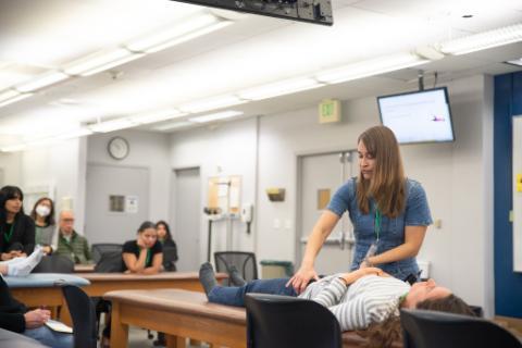 Dr. Jennifer Kinder demonstrates a technique in front of a class