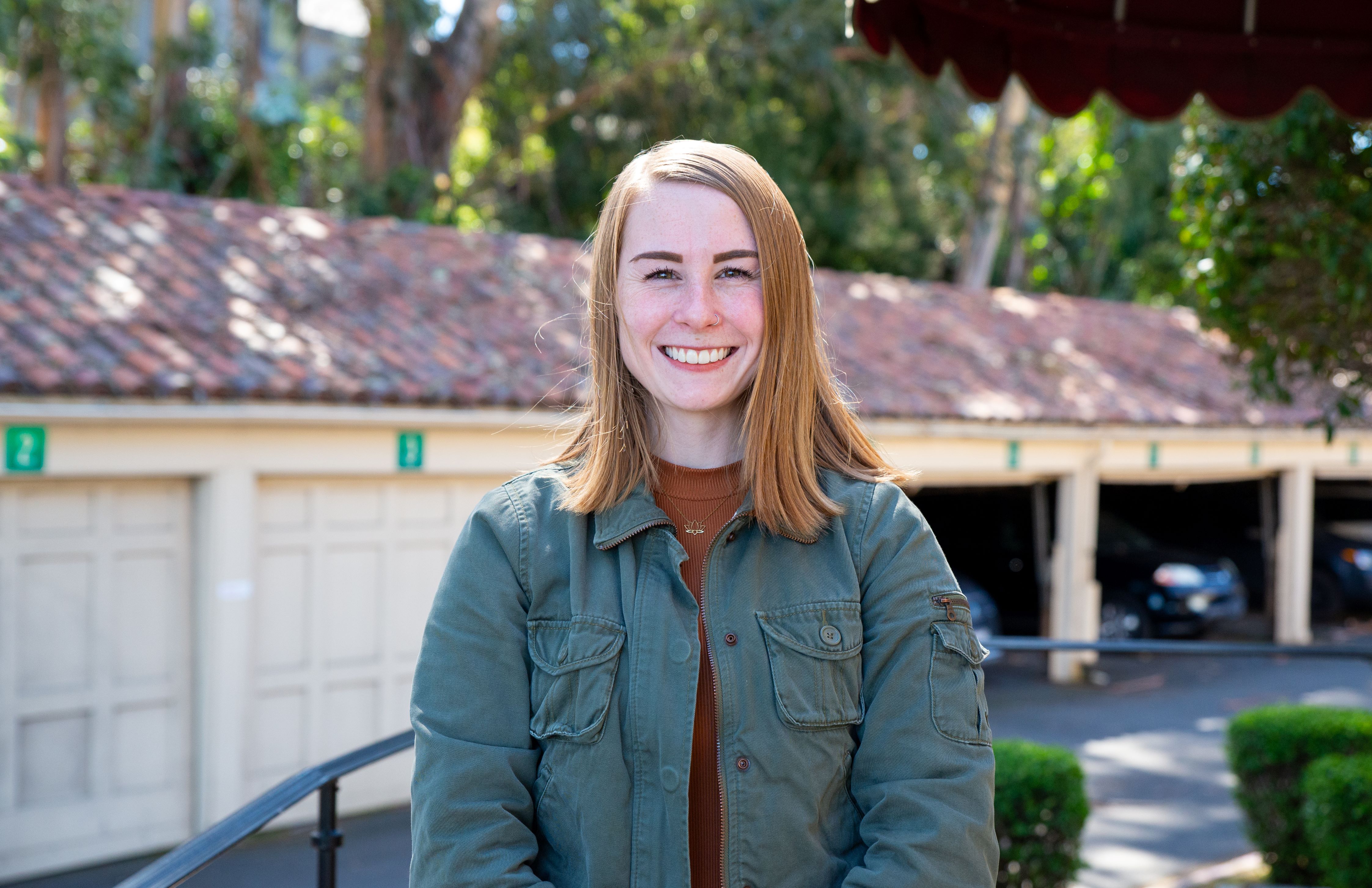 A photo shows Madison Sisk as she stands outside of Wilderman Hall at Touro University California after being selected as a Fellow with the California Department of Public Health Epidemiologic Investigation Service.