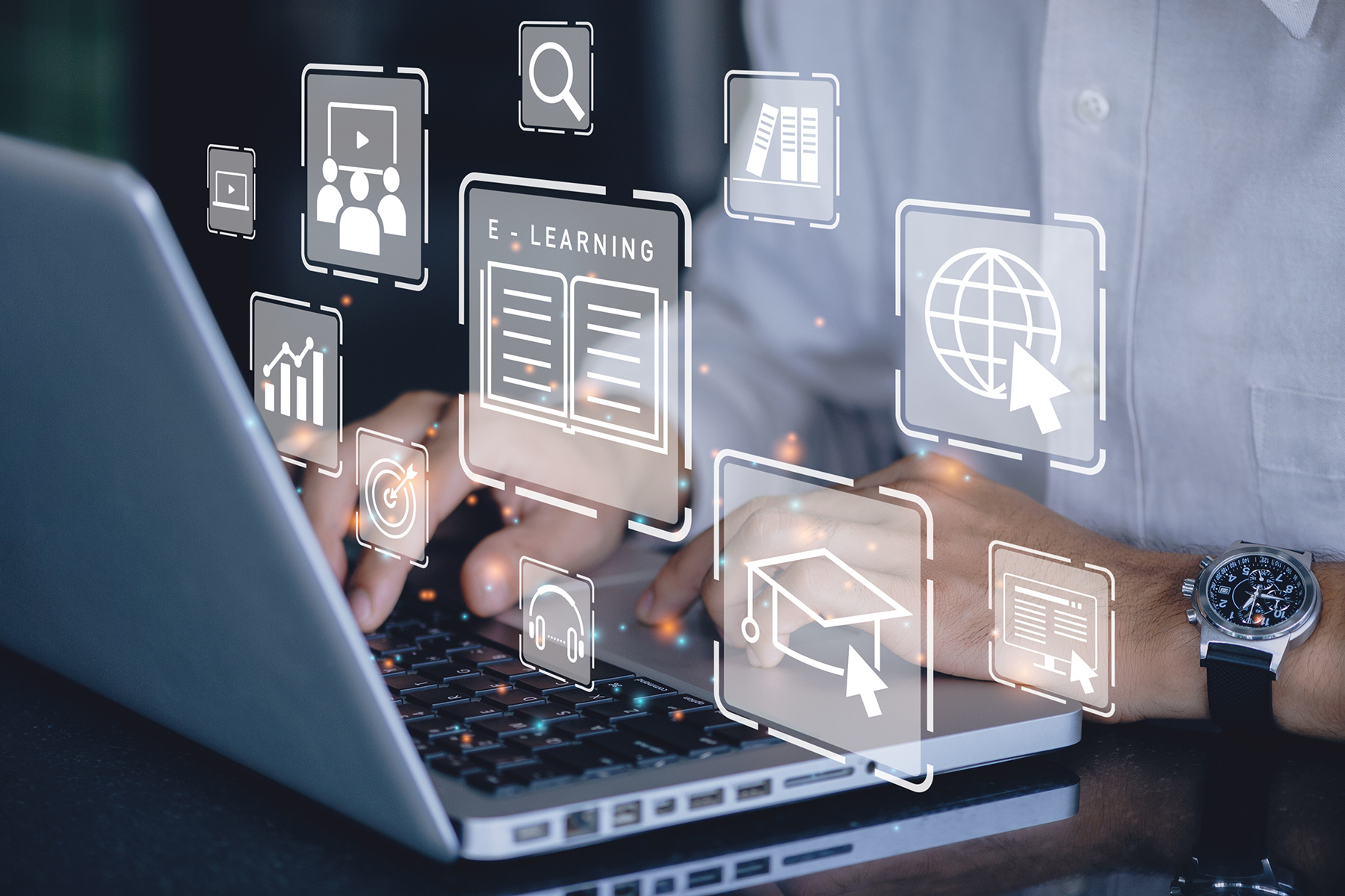 laptop with various application icons hovering above it