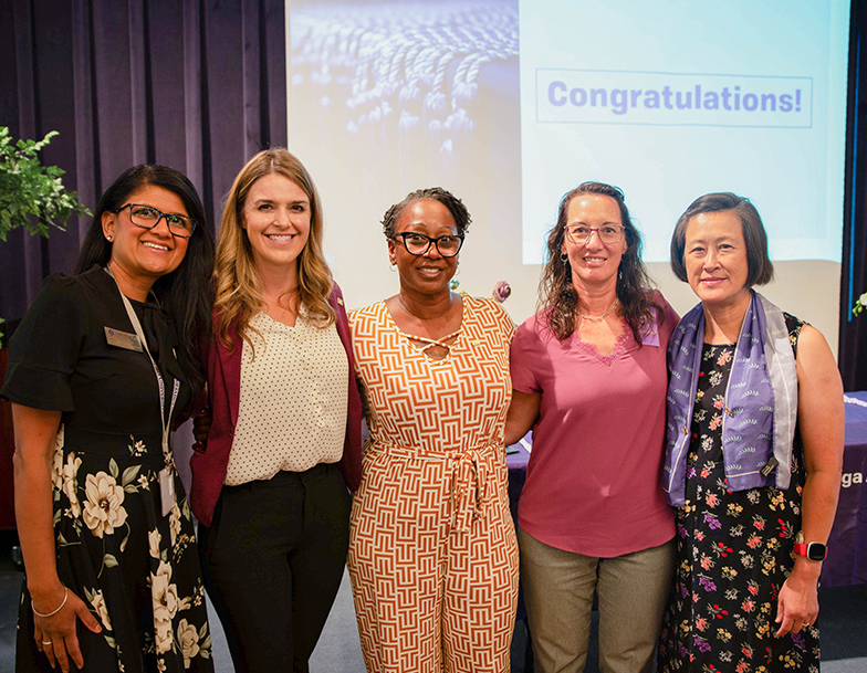 A photo shows Dr. Prabjot “Jodie” Sandhu, Director of the School of Nursing (left) with program alumnae (left to right) Jennifer Tudor (Class of 2015), Nikitia “Niki” Hardwick (Class of 2021), Jennifer Veler (Class of 2019), and Vivian Chu (Class of 2020) during a Nursing Honors ceremony on campus, Thursday, Sept. 14, 2023.