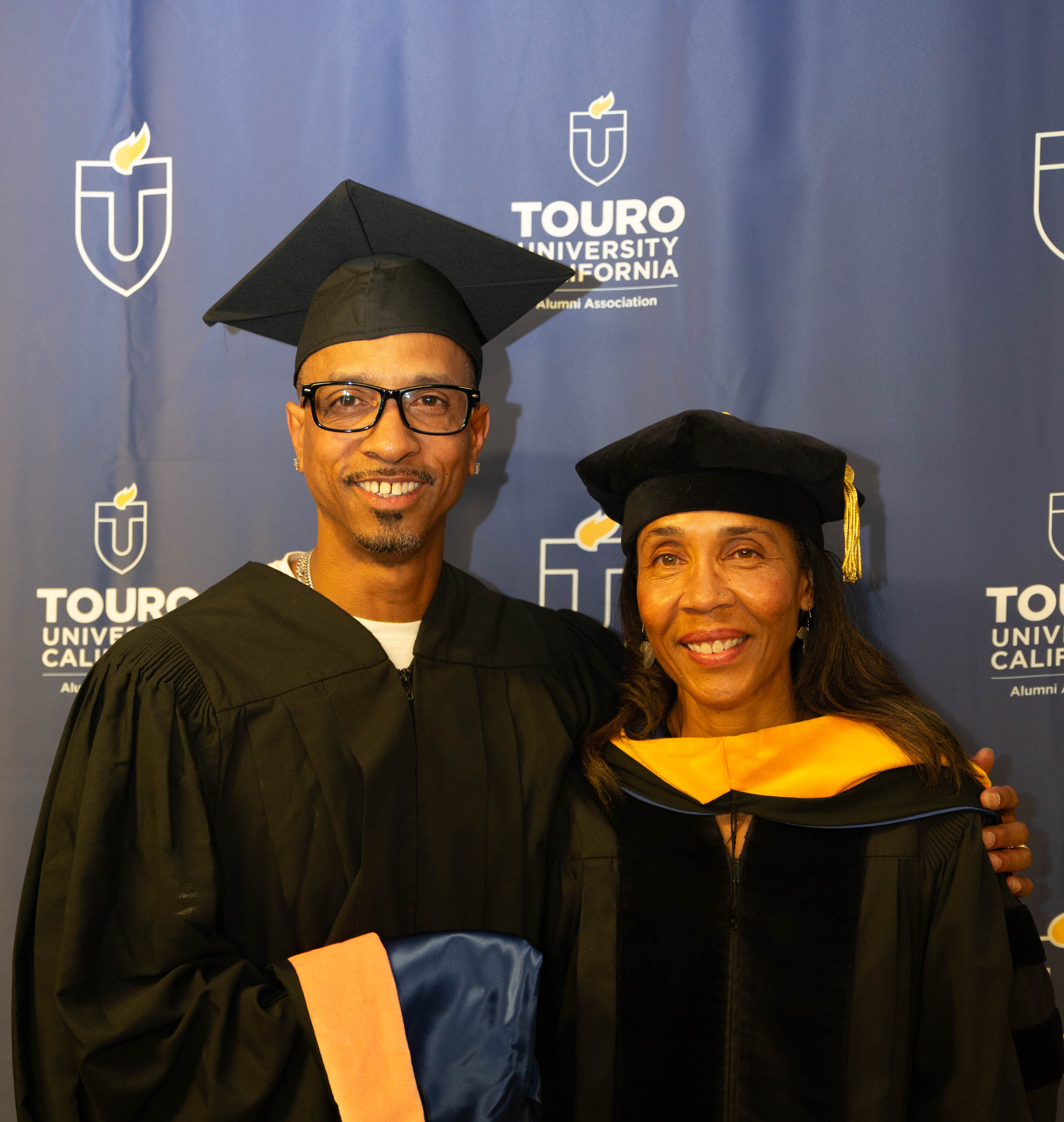 Obie Anthony and Gayle Cummings pose for a photo at Touro California\'s commencement.