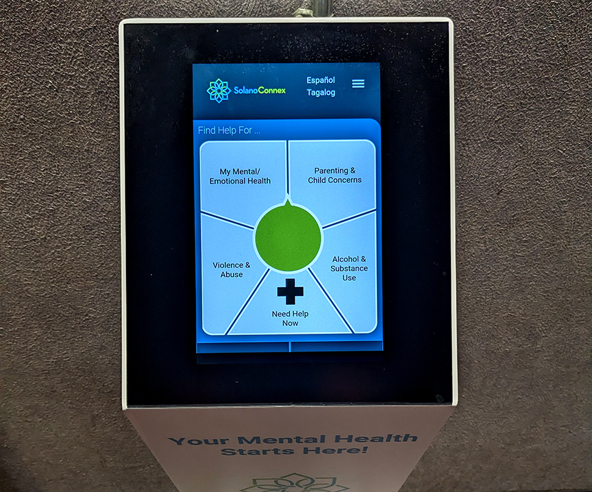 A SolanoConnex mental health kiosk is displayed inside a branch of the Solano library.